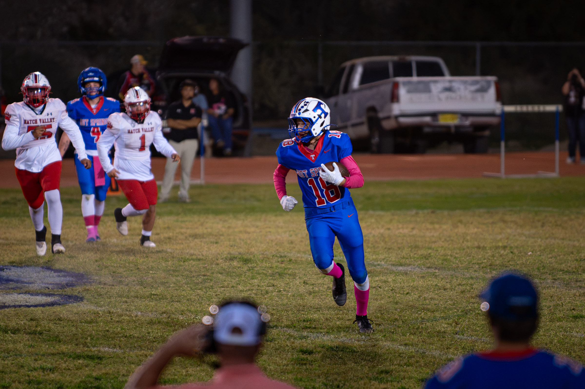 Hot Springs wide receiver Billy Baca (#18) runs after a reception as Hatch Valley defenders pursue him.