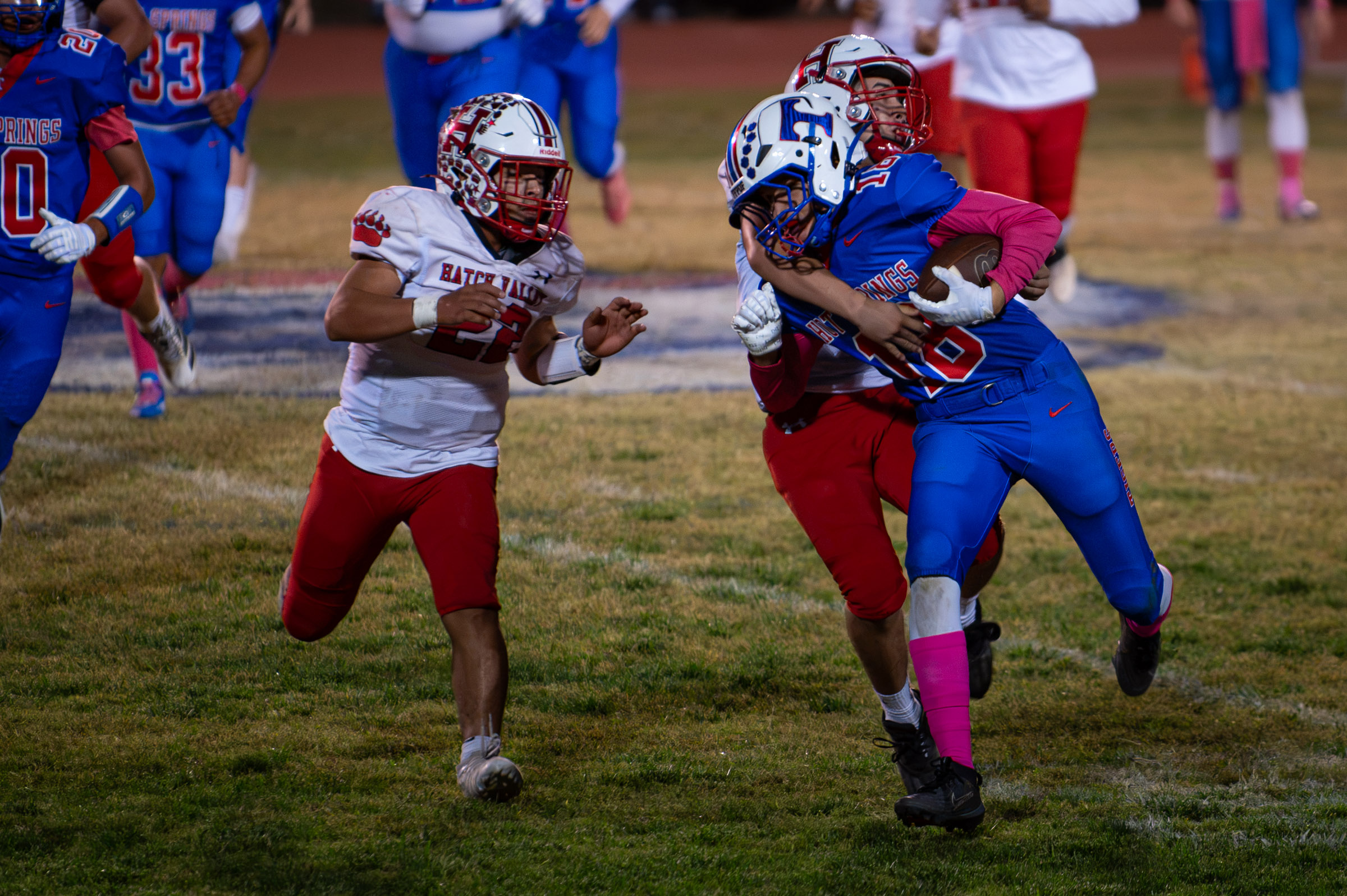 Hot Springs wide receiver Billy Baca (#18) fights through a tackle by a Hatch Valley defender after making a reception.