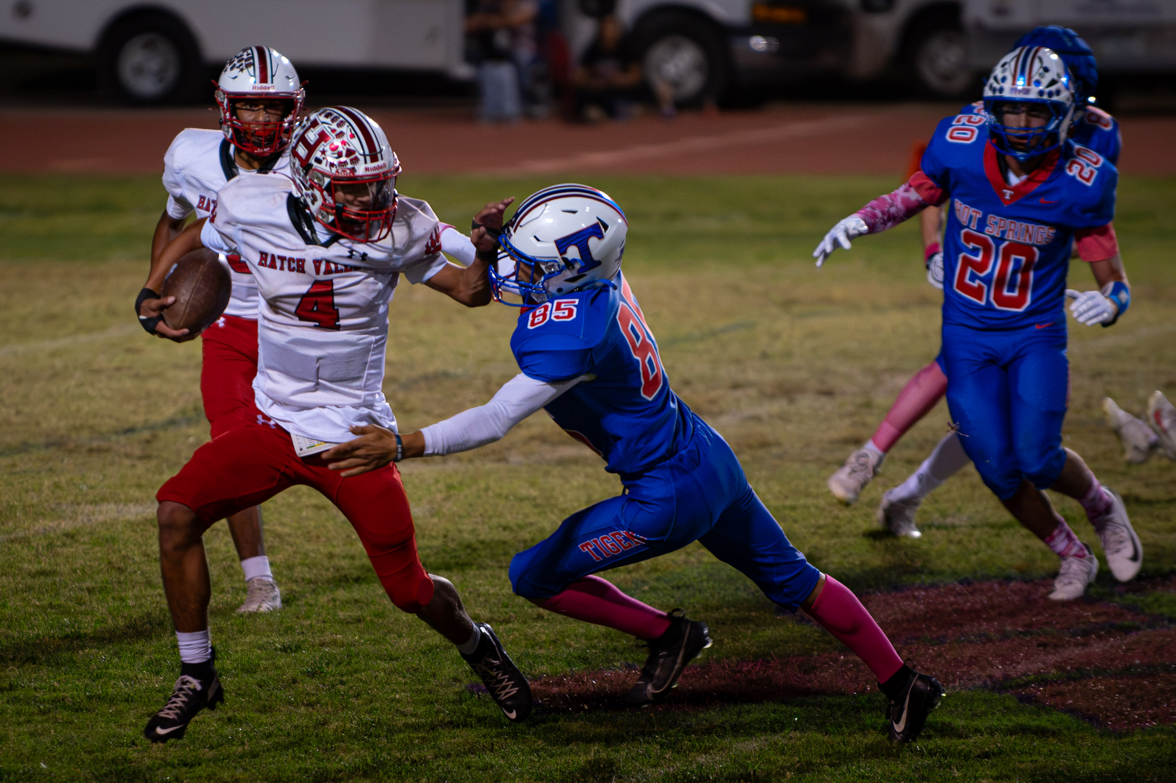 Hatch Valley’s Nano Turner (#4) carries the ball on a kickoff return as Hot Springs defenders close in.