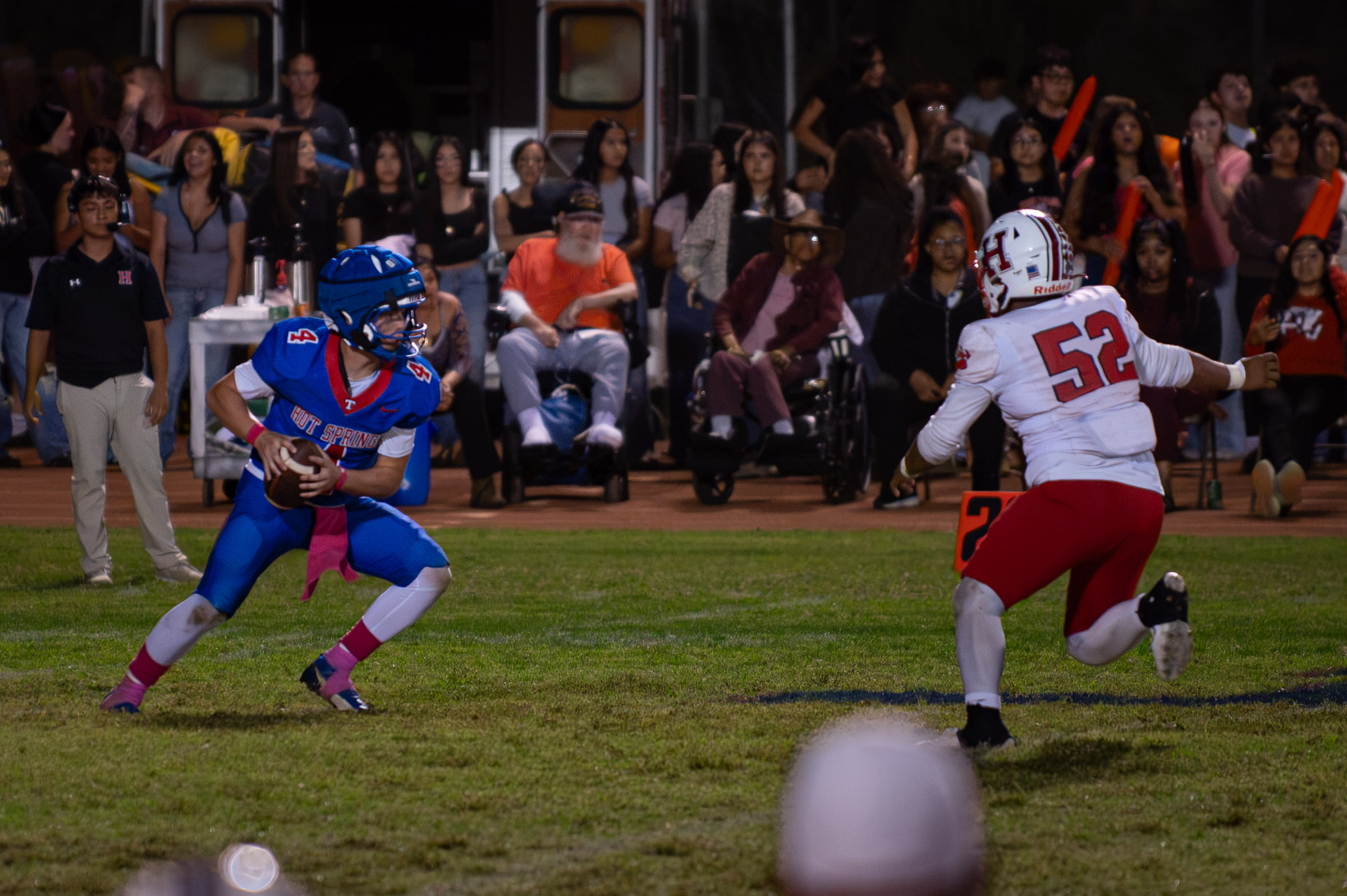 Hot Springs quarterback Zaiden Baker (#4) carries the ball while facing a Hatch Valley defender in the open field.