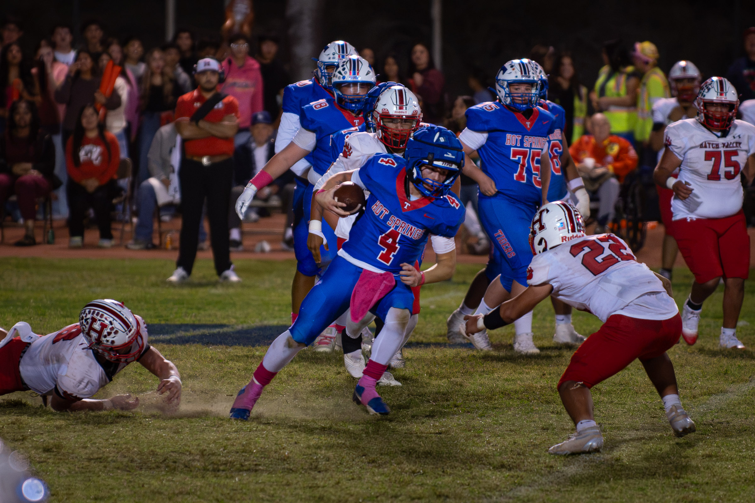 Hot Springs quarterback Zaiden Baker (#4) cuts upfield with the ball toward Hatch Valley’s Felipe Carranza (#22) after evading a defender.