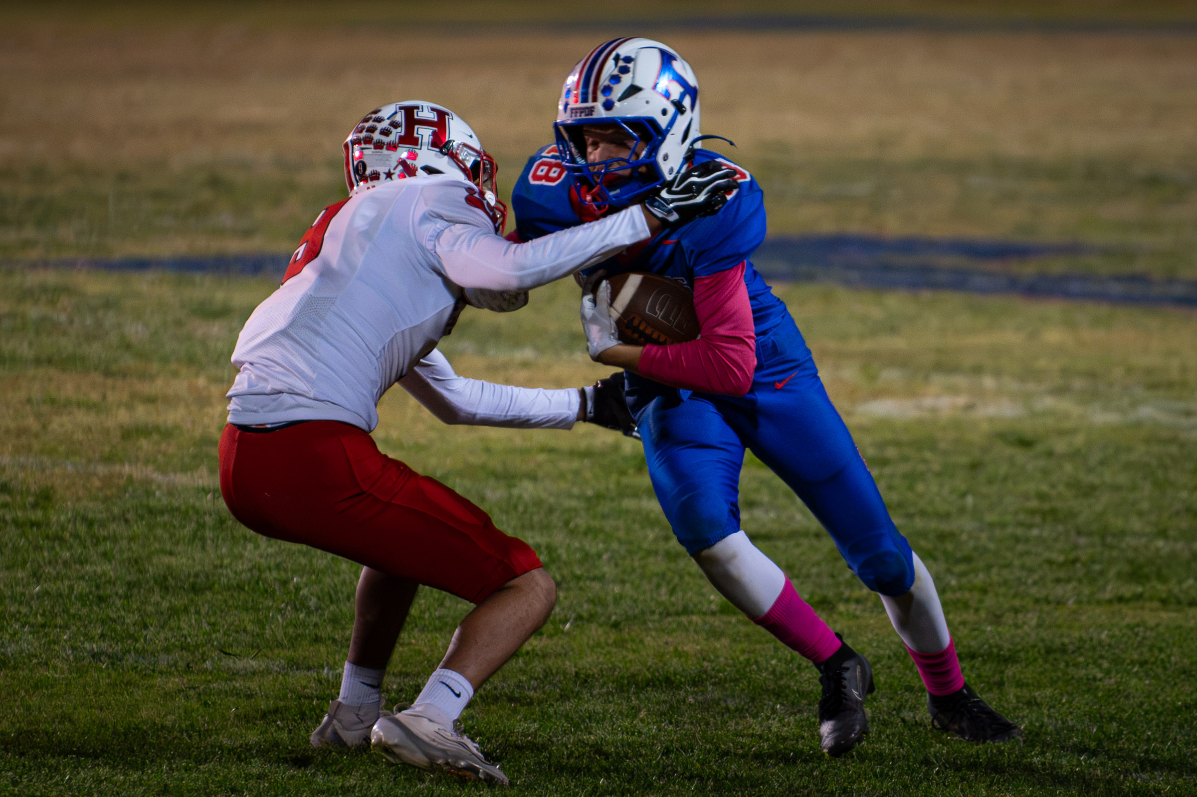Hot Springs senior Billy Baca (#18) takes contact from a Hatch Valley defender after making a reception.