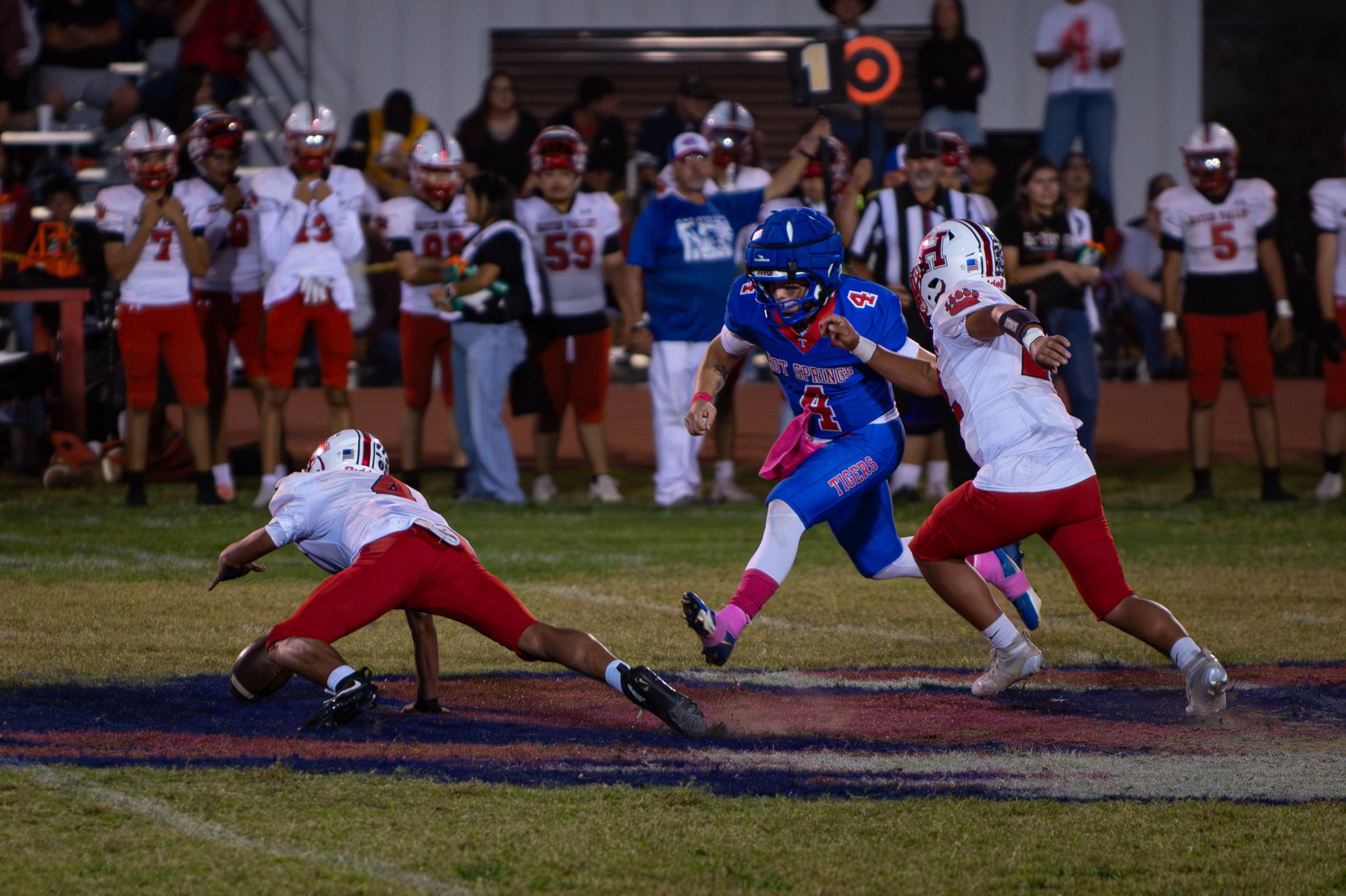 Hot Springs defensive back Zaiden Baker (#4) and Hatch Valley quarterback Nano Turner (#4) converge on a loose ball following a bad snap.